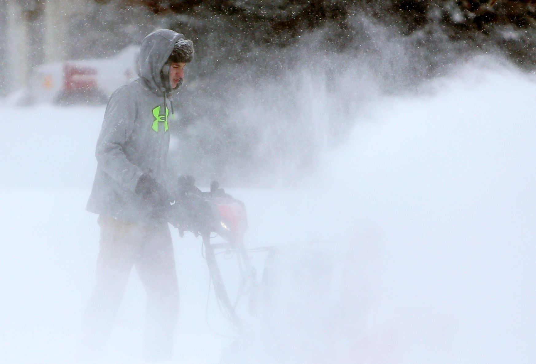 Taylor Whittle snowblows his driveway